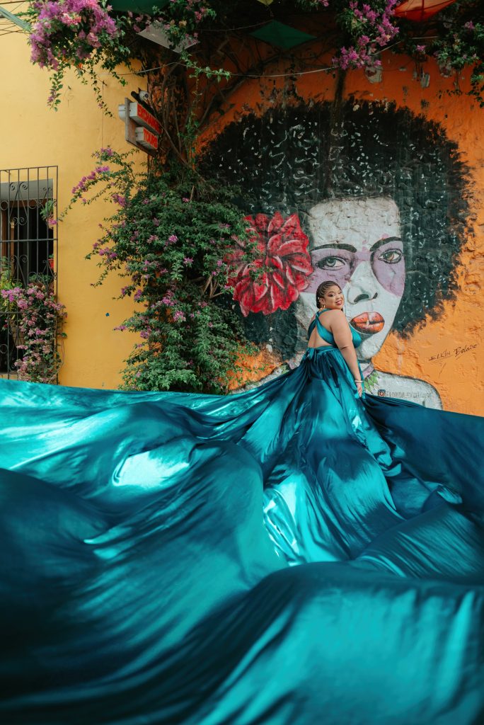 Flying Dress Cartagena a woman in an electric teal flying dress for a photoshoot in Getsemani neighborhood of Cartagena Colombia