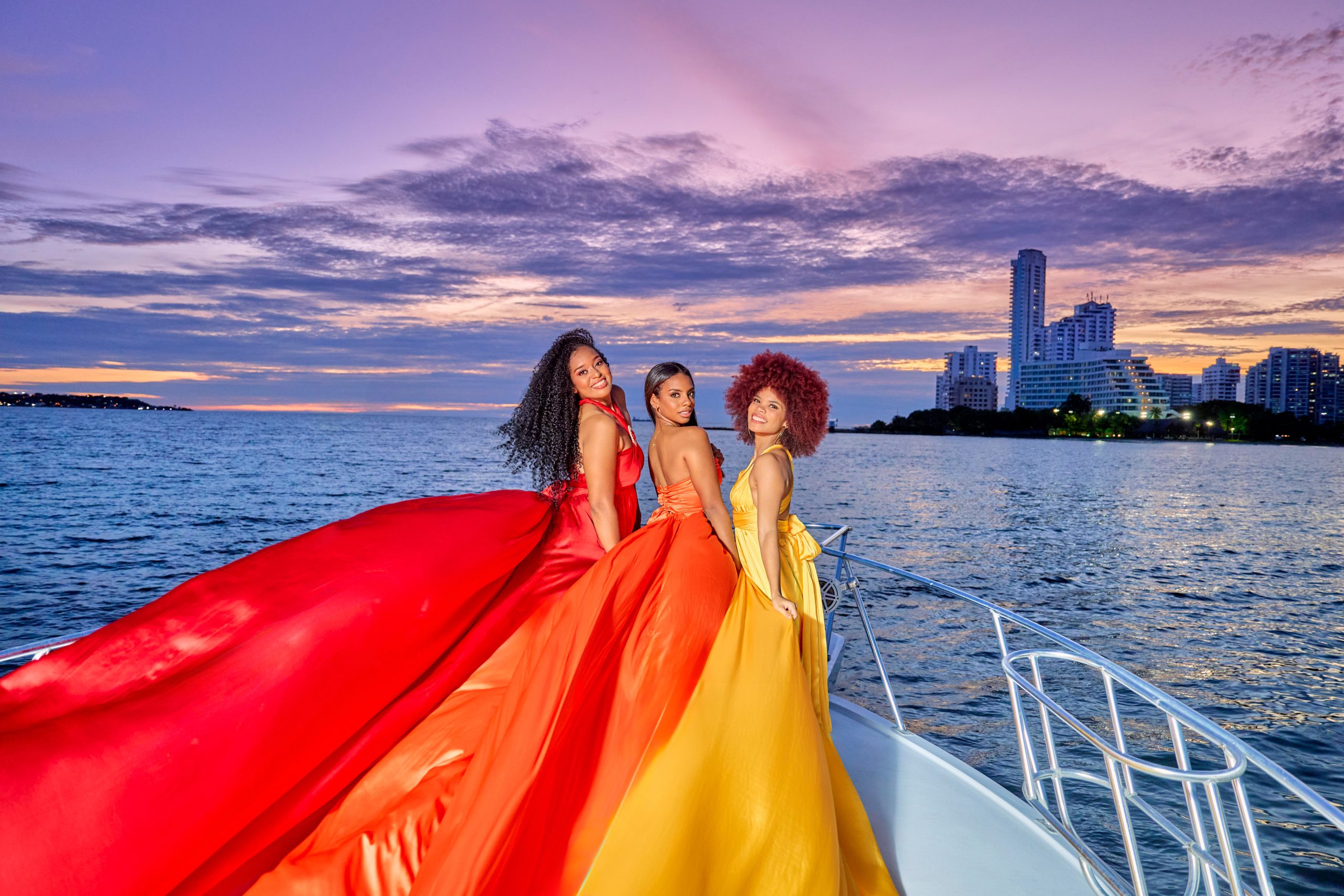 Group flying dress photoshoot on a yacht at sunset in Cartagena Bay