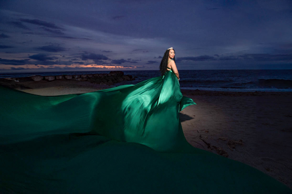 Flying Dress Cartagena photoshoot with a Woman in flowing green dress at beach
