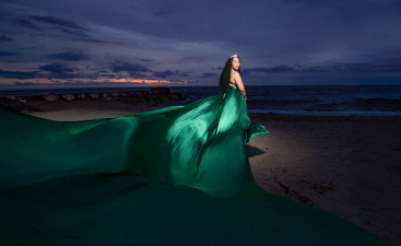 Flying Dress Cartagena photoshoot with a Woman in flowing green dress at beach