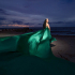 Flying Dress Cartagena photoshoot with a Woman in flowing green dress at beach