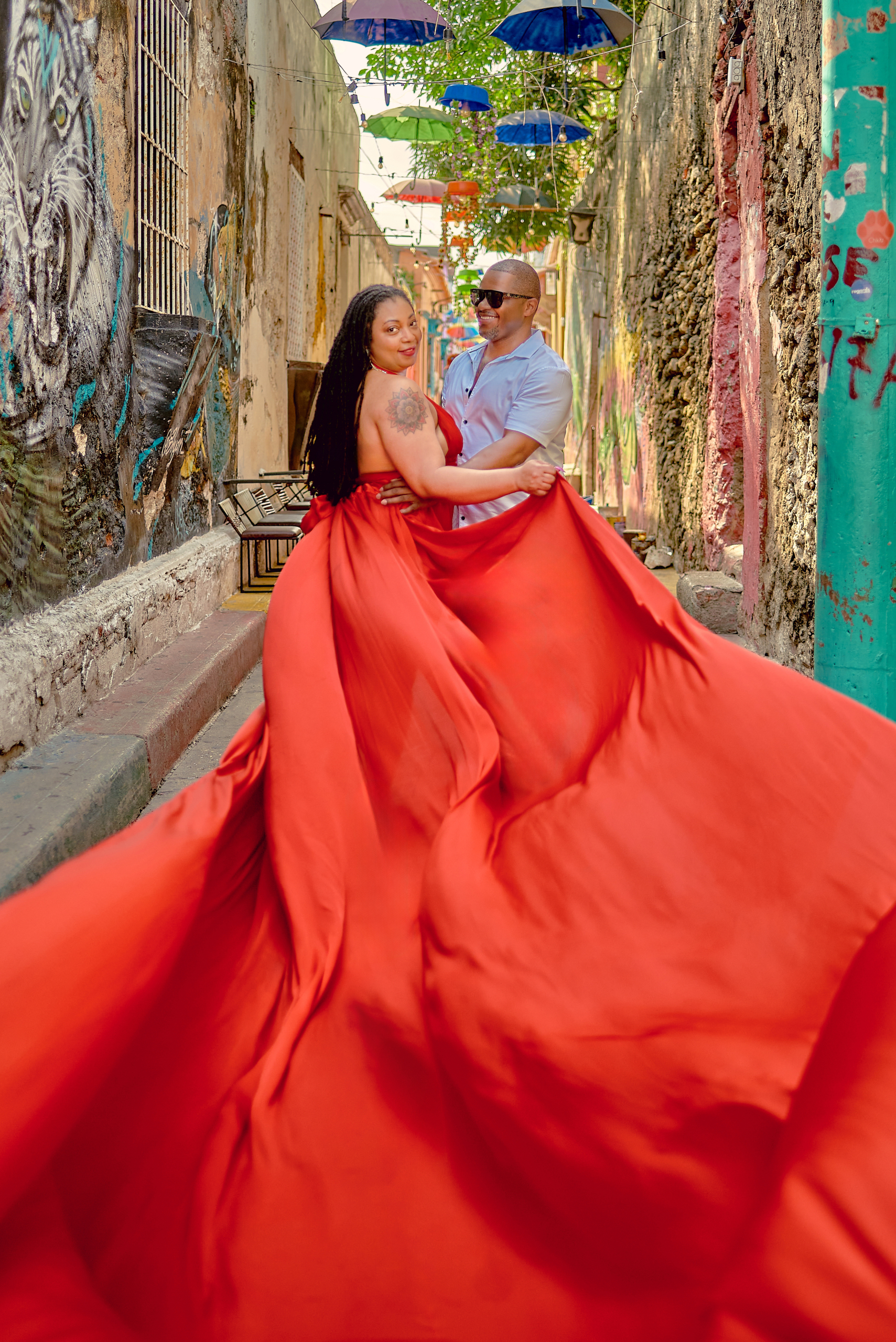 Coral flying dress in motion on a Cartagena street