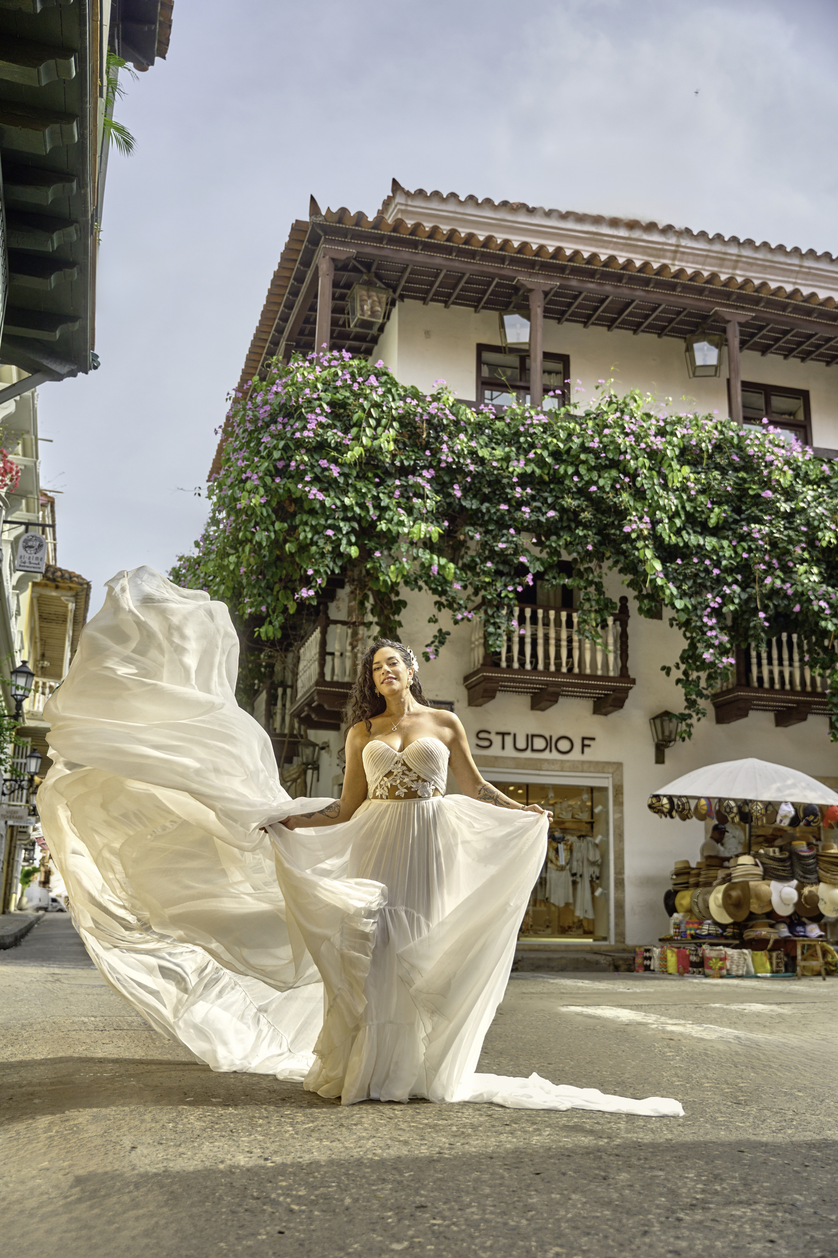 White flying dress photoshoot on a street in the Old City of Cartagena