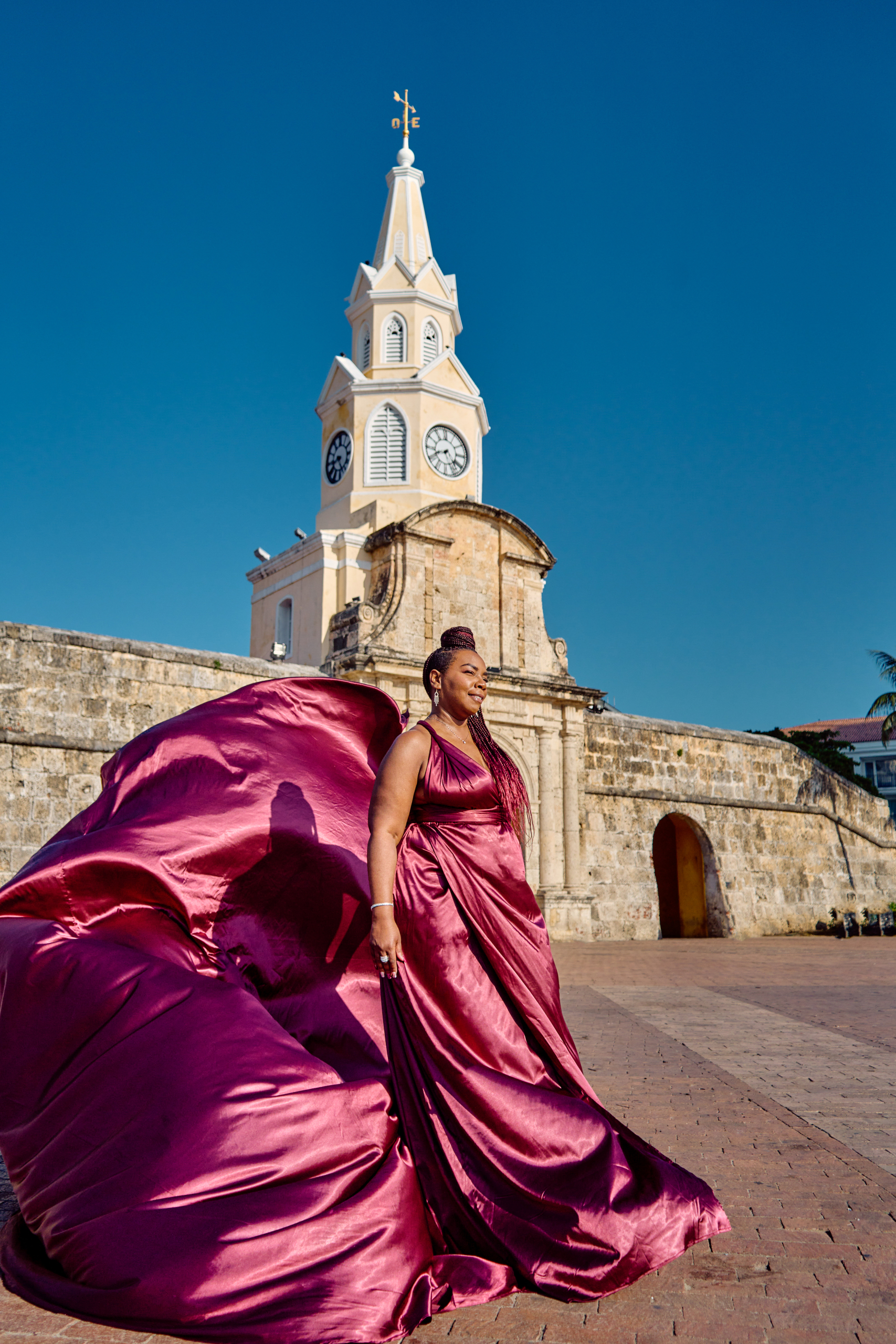 Burgundy flying dress photoshoot at the Clock Tower in the Old City of Cartagena