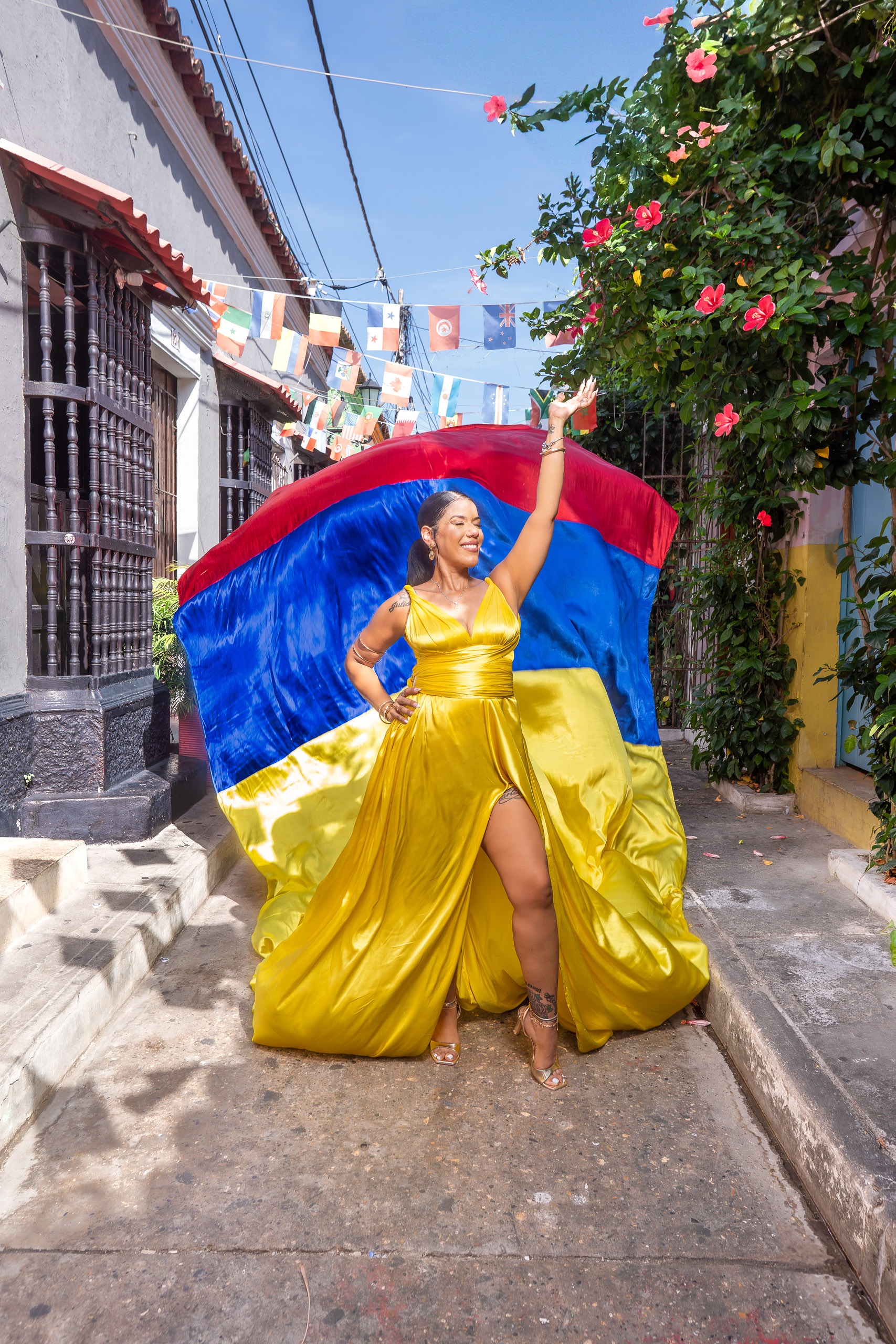 Birthday flying dress photoshoot in Colombia colors on a street in Cartagena