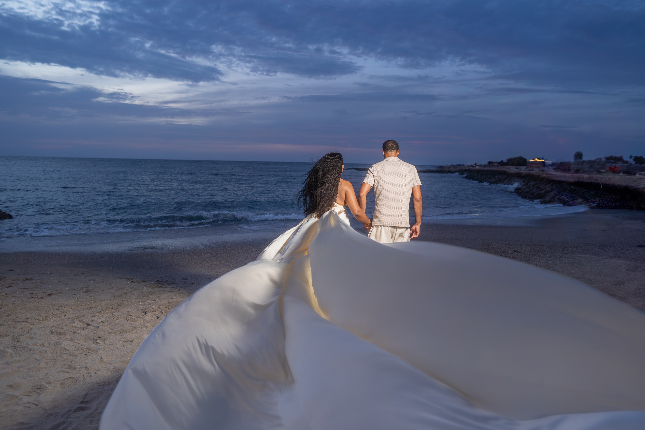 Couple flying dress photoshoot on the beach in Cartagena at dusk